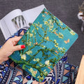 Handmade liquid silicone iPad flip case in apricot flower colour on a table