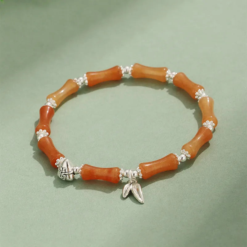 Green aventurine bamboo strawberry quartz crystal bracelet with mixed natural stones on wrist