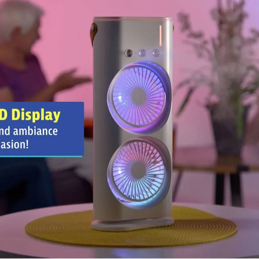 White portable humidifier fan with two spray heads, remote control, and coloured LED lights on a desk.