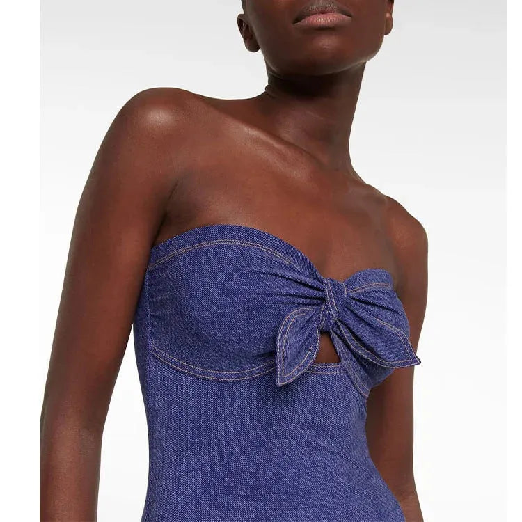 Women's vintage denim-colour one-piece swimsuit with a matching skirt laid flat.