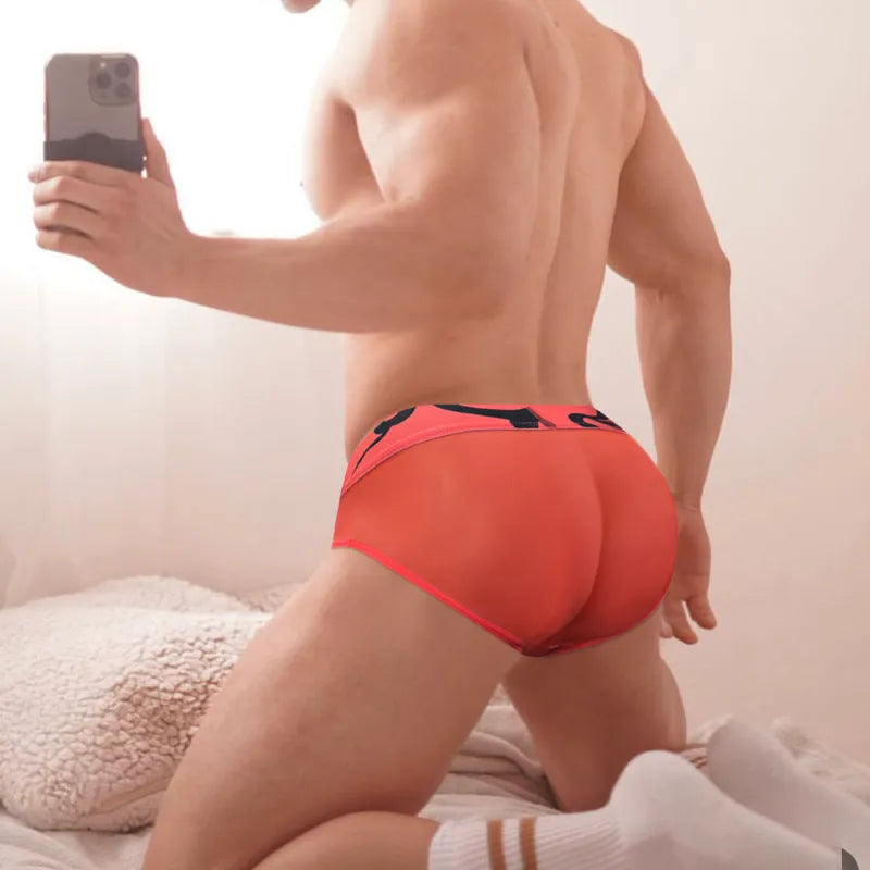 Men's solid colour cotton modal boxer shorts in black, pink, or red on a white background.