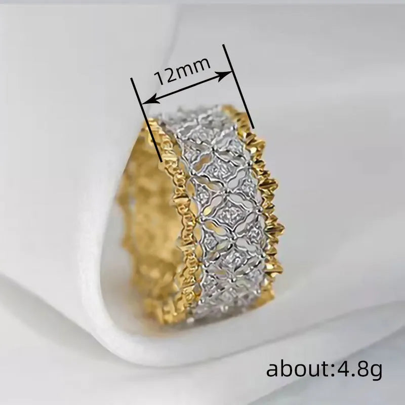 Geometric two-tone gold and silver zircon ring on a copper base, showing round stone detail.