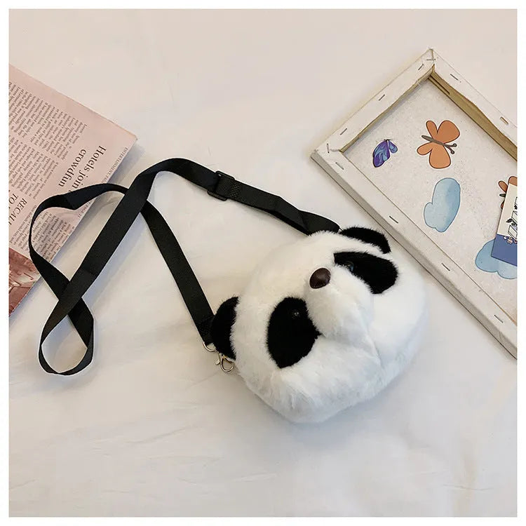 Soft plush panda head crossbody bag with cylindrical shape and sandwich pocket.