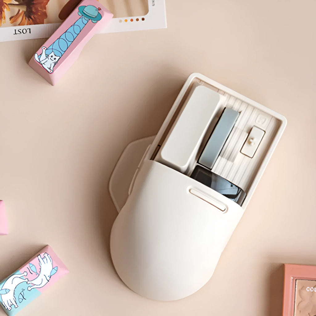 Tofu coloured Xiaoqiao wireless mouse on a desk, showing its ergonomic shape and seven buttons.