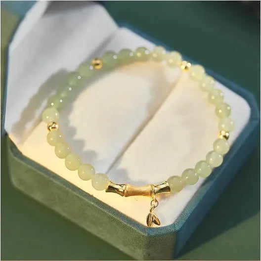 Bamboo style bracelet with electroplated coloured glass beads in a Ruyi flower design.