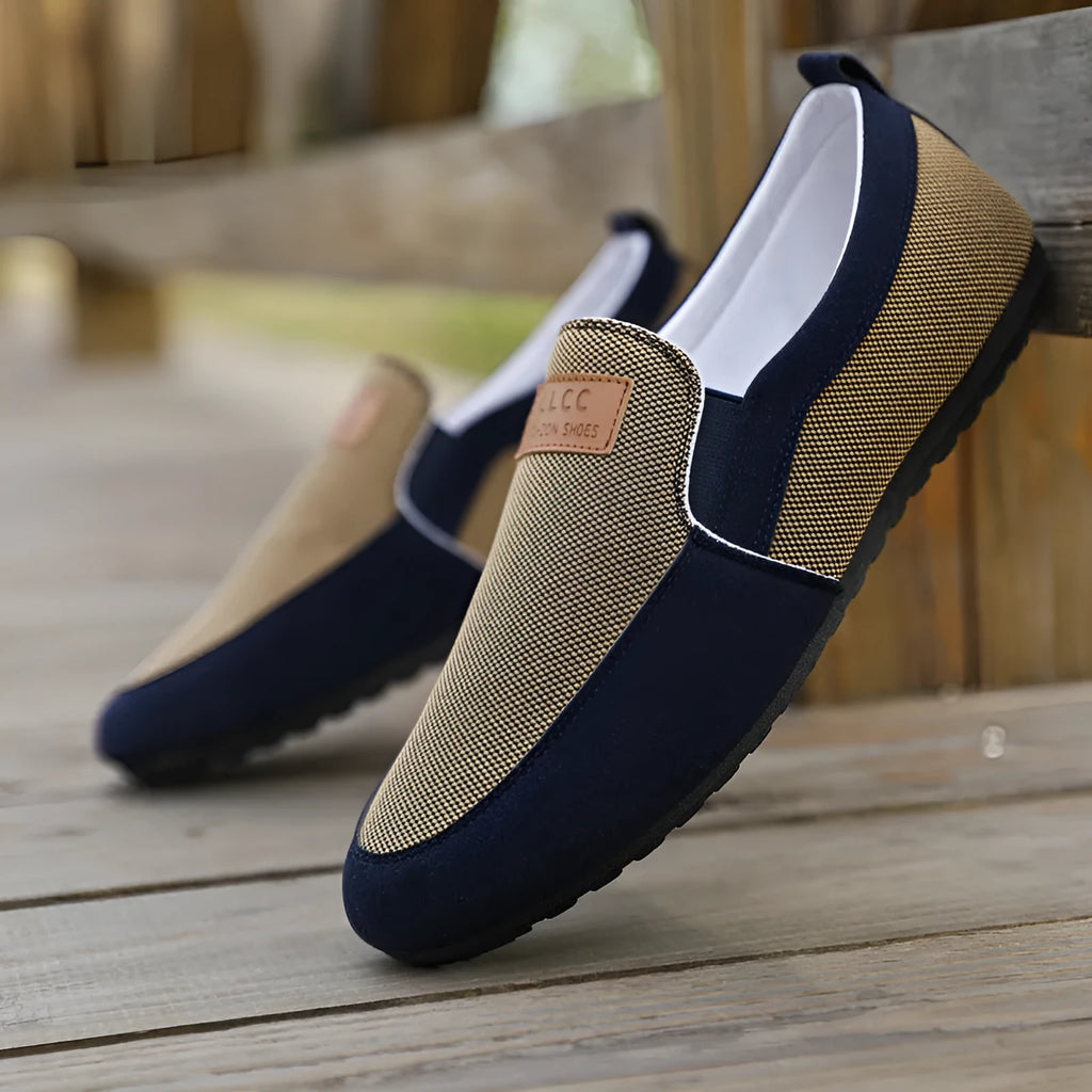Men's grey and khaki canvas slip-on board shoes with round toe and rubber sole.