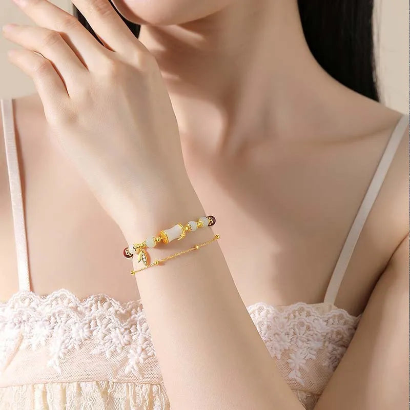 Bamboo style bracelet with electroplated coloured glass beads in a Ruyi flower design.