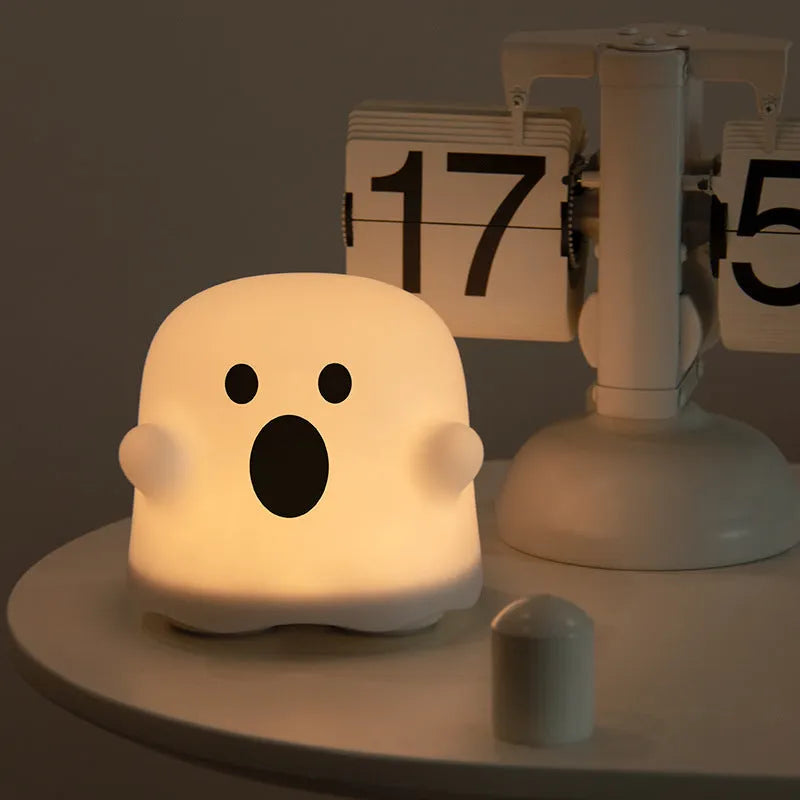 White portable LED touch sensor night light on a wooden bedside table.