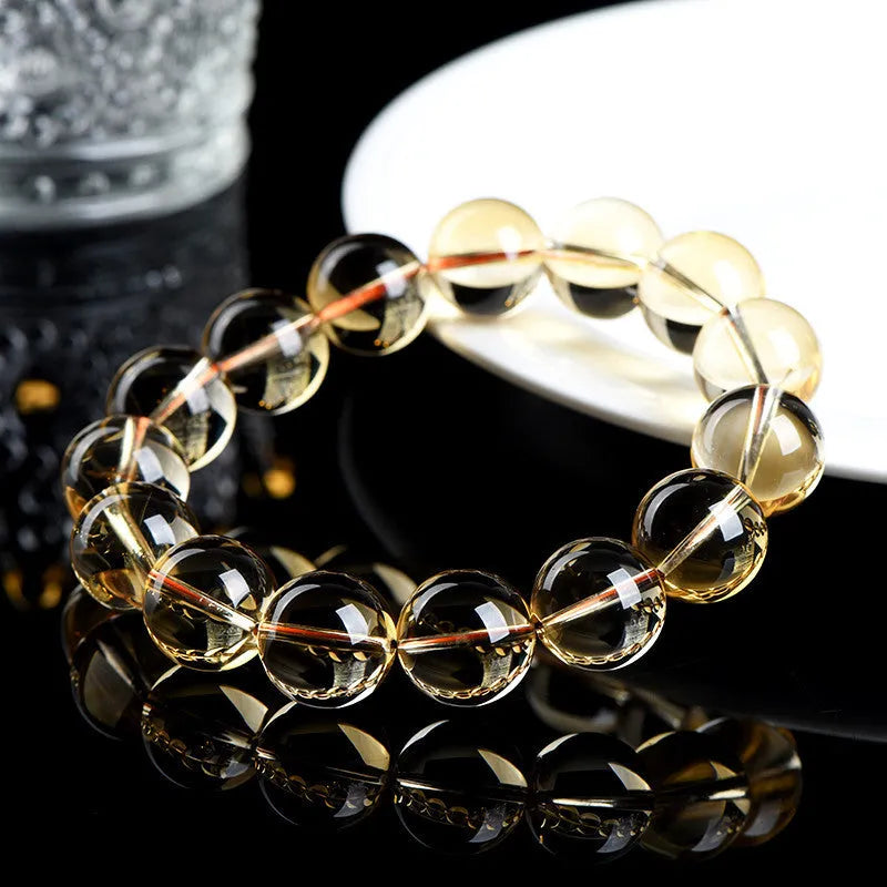 Natural citrine scattered beads ball bracelet on wrist, showing polished beads in 7A grade colour.