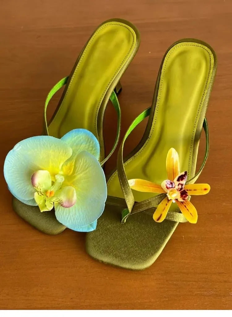 Handmade women's high-heel sandals with an asymmetric flower design on a calf leather upper.