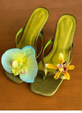 Handmade women's high-heel sandals with an asymmetric flower design on a calf leather upper.
