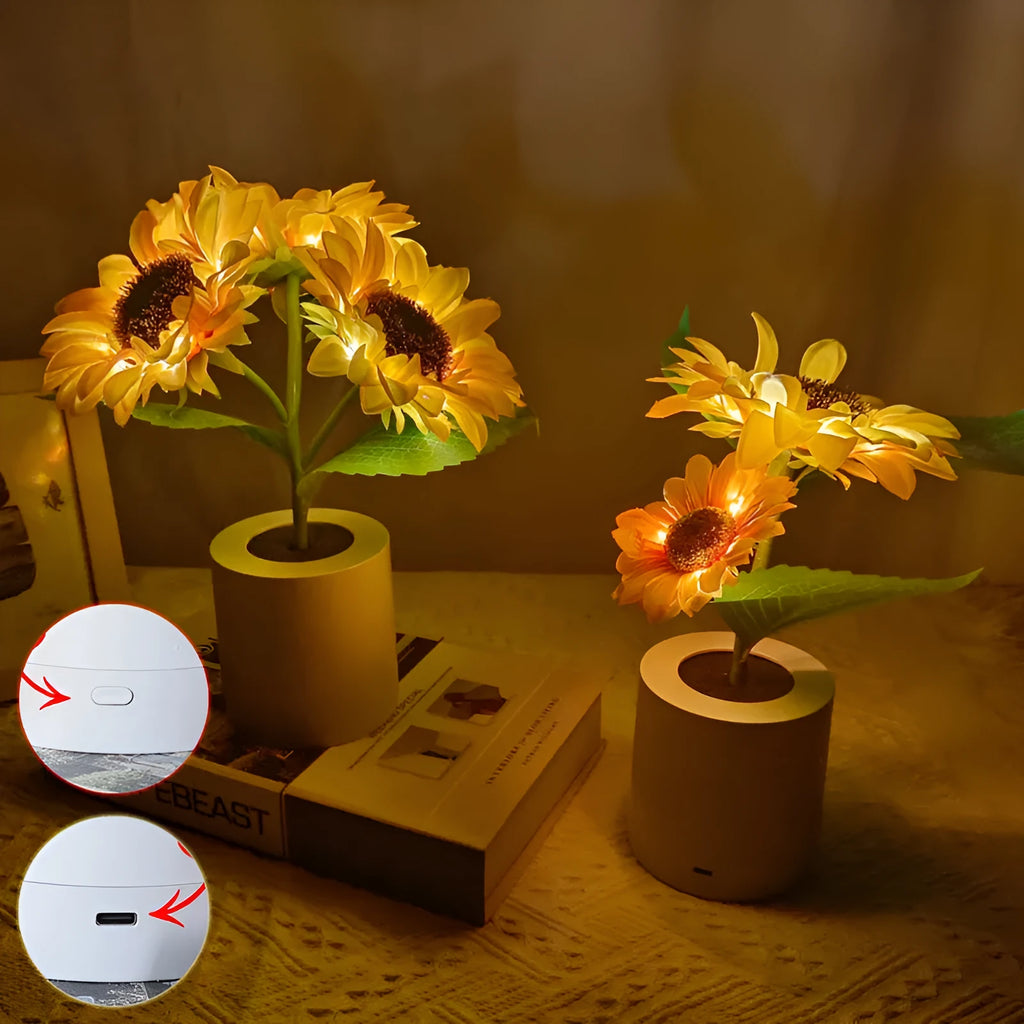Rechargeable artificial sunflower LED table lamp with USB cable on wooden surface.
