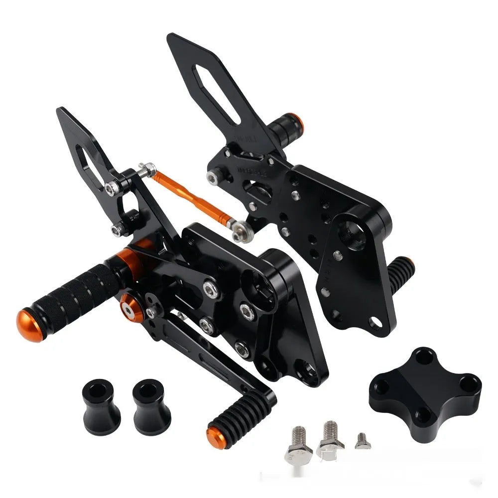Black and orange KTM Duke motorcycle raised footrest bracket assembly
