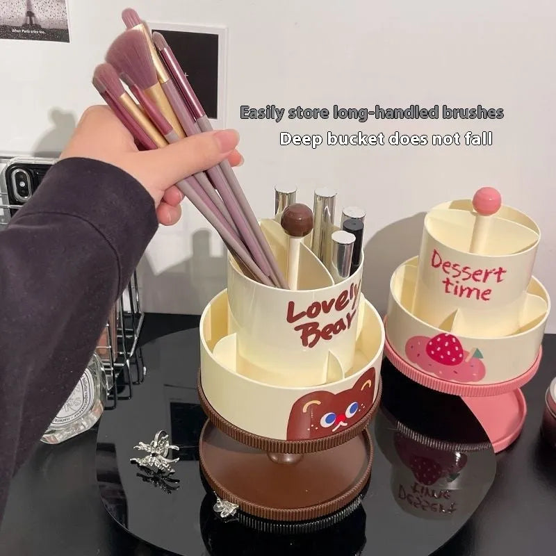 Rotating cosmetic brush storage barrel in a choice of colours on a table, showing its carousel design.