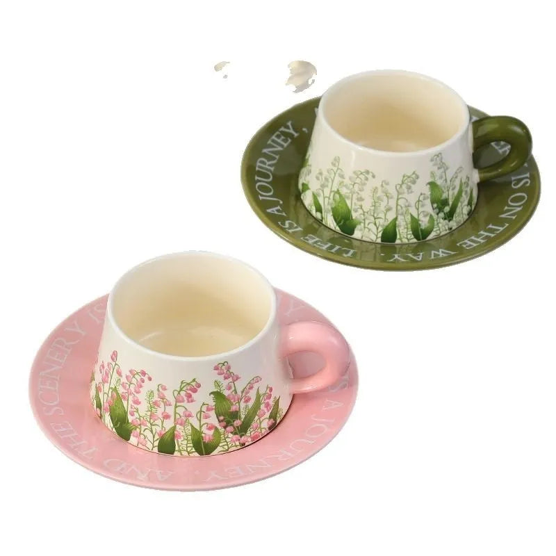 Ceramic coffee cup and saucer set for two with stirring spoons in two design choices.