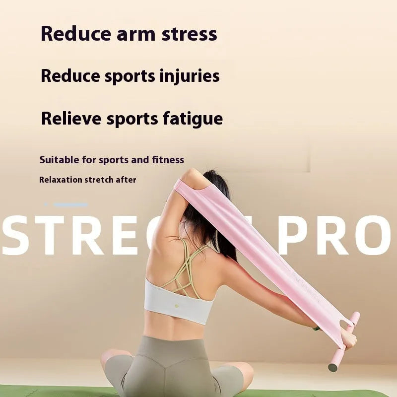 Grey and pink yoga stretching tool for shoulders, back, and hips on a fitness mat.