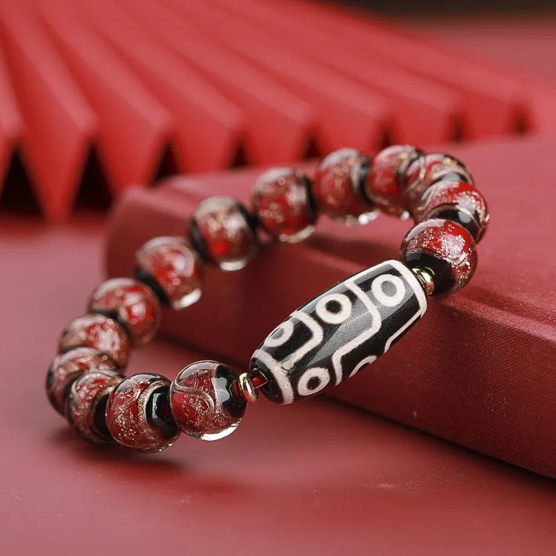 Chinese-style bracelet with coloured glaze beads showing snake and multi-treasure patterns.