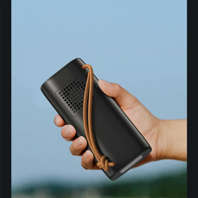 Black portable power bank with digital display, solar panel, and 220V AC outlets for outdoor use.