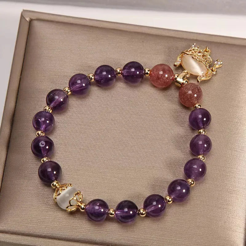Handmade copper bracelet for women with a natural amethyst drop charm and longevity lock symbol.