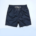 Men's striped polyester shorts in navy blue on a mannequin, showing straight leg design.