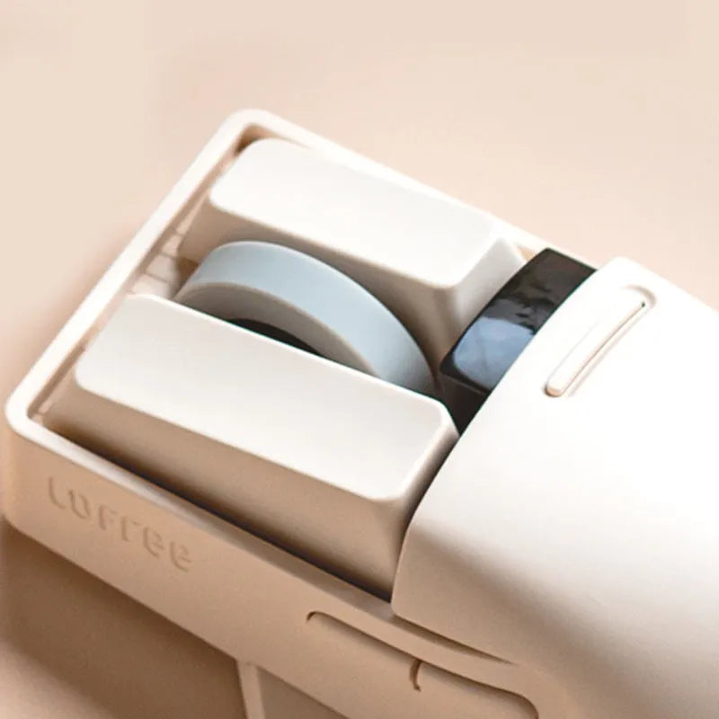 Tofu coloured Xiaoqiao wireless mouse on a desk, showing its ergonomic shape and seven buttons.