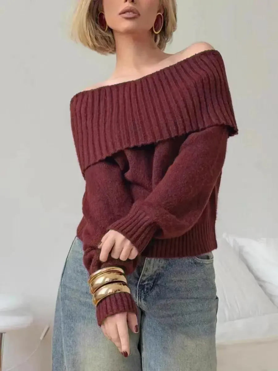 Grey off-the-shoulder women's sweater with a 3D pattern and regular sleeves on a hanger.