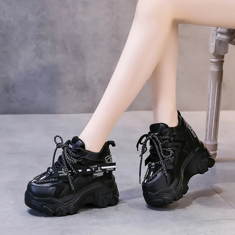 Women's white mesh platform sports shoes with a cross strap and rubber sole.
