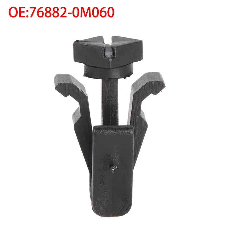 Black plastic bumper cover and radiator grille fastening clip for Nissan vehicles, model 76882-0M060.