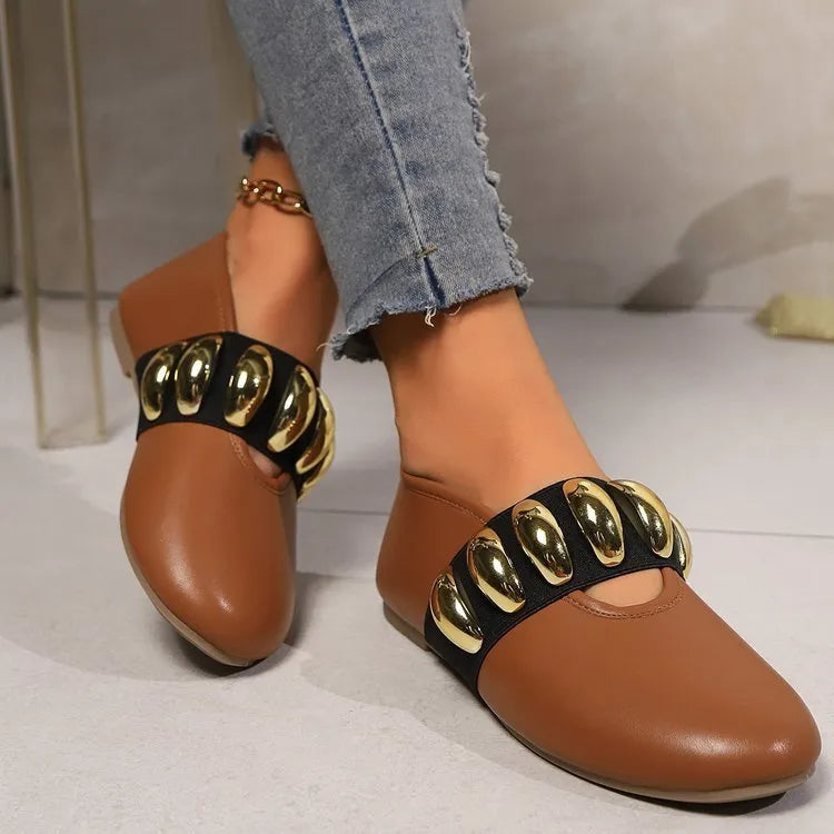 Women's brown flat loafers with metal buckle and round toe on artificial PU upper