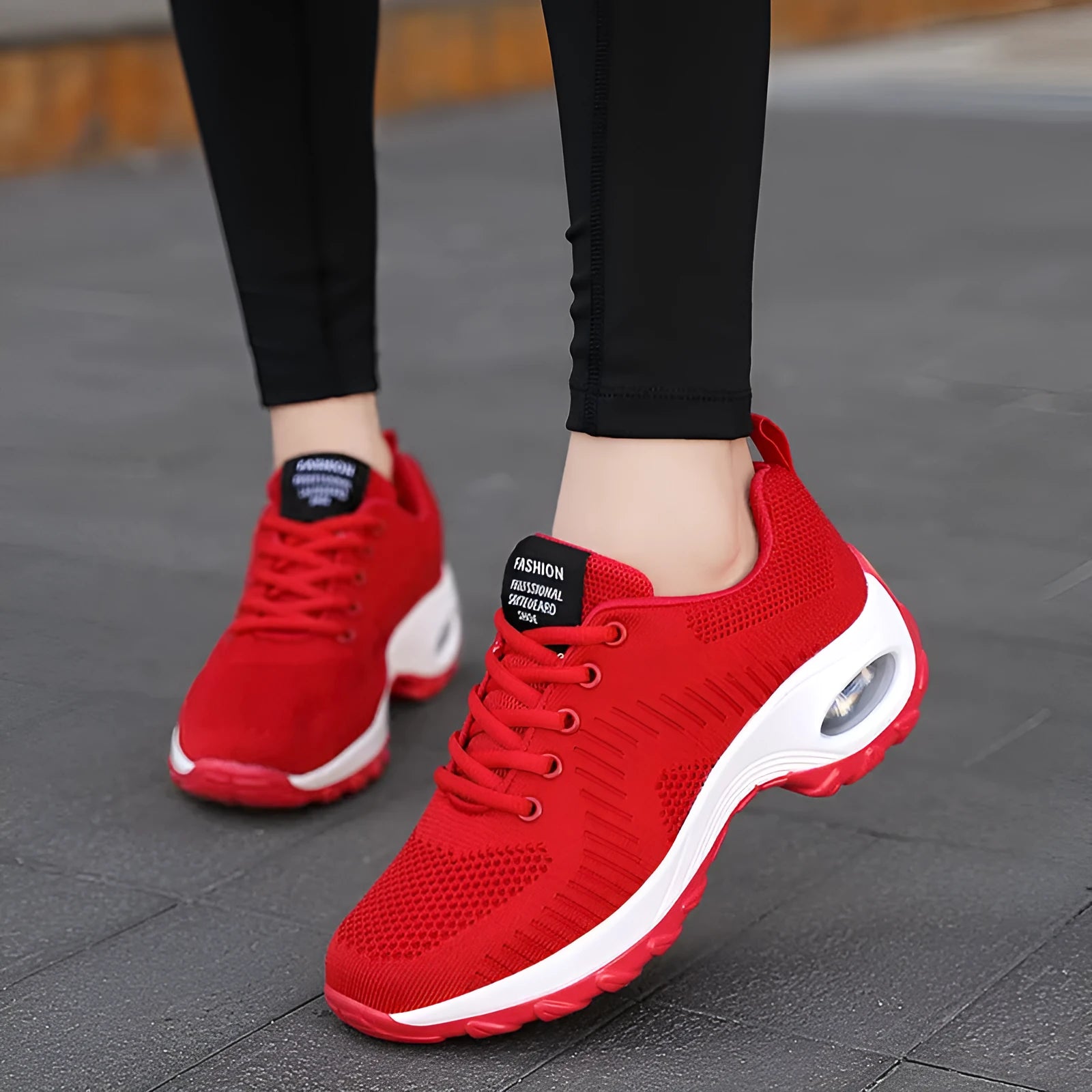 Red women's low-top mesh sneakers with front laces and a round toe on a flat PU sole.