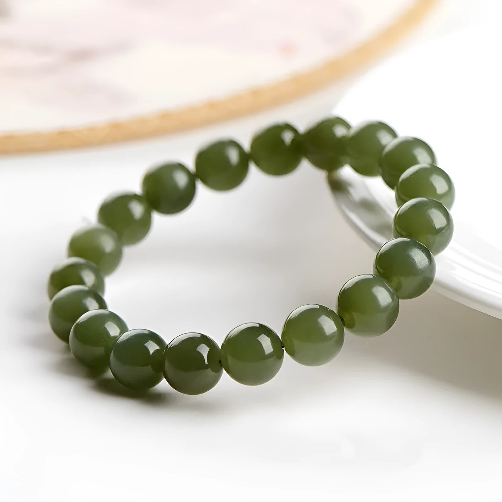 Unisex Hetian jade ball bead bracelet in ice clear colours, showing polished spherical beads on a string.