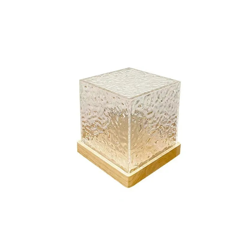 LED water ripple projection crystal table lamp with remote control on wooden surface