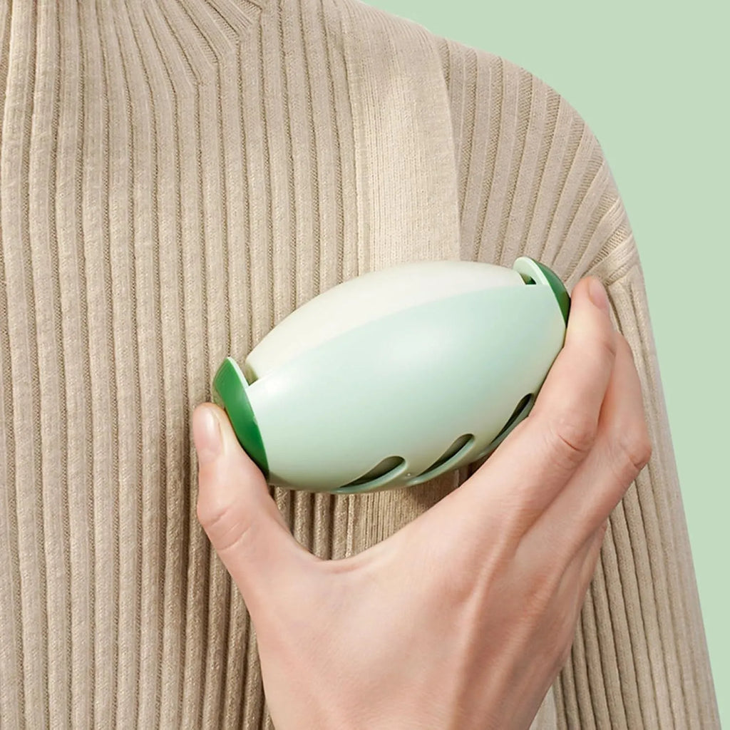 Green and white washable reusable gel lint roller balls for portable pet hair removal.