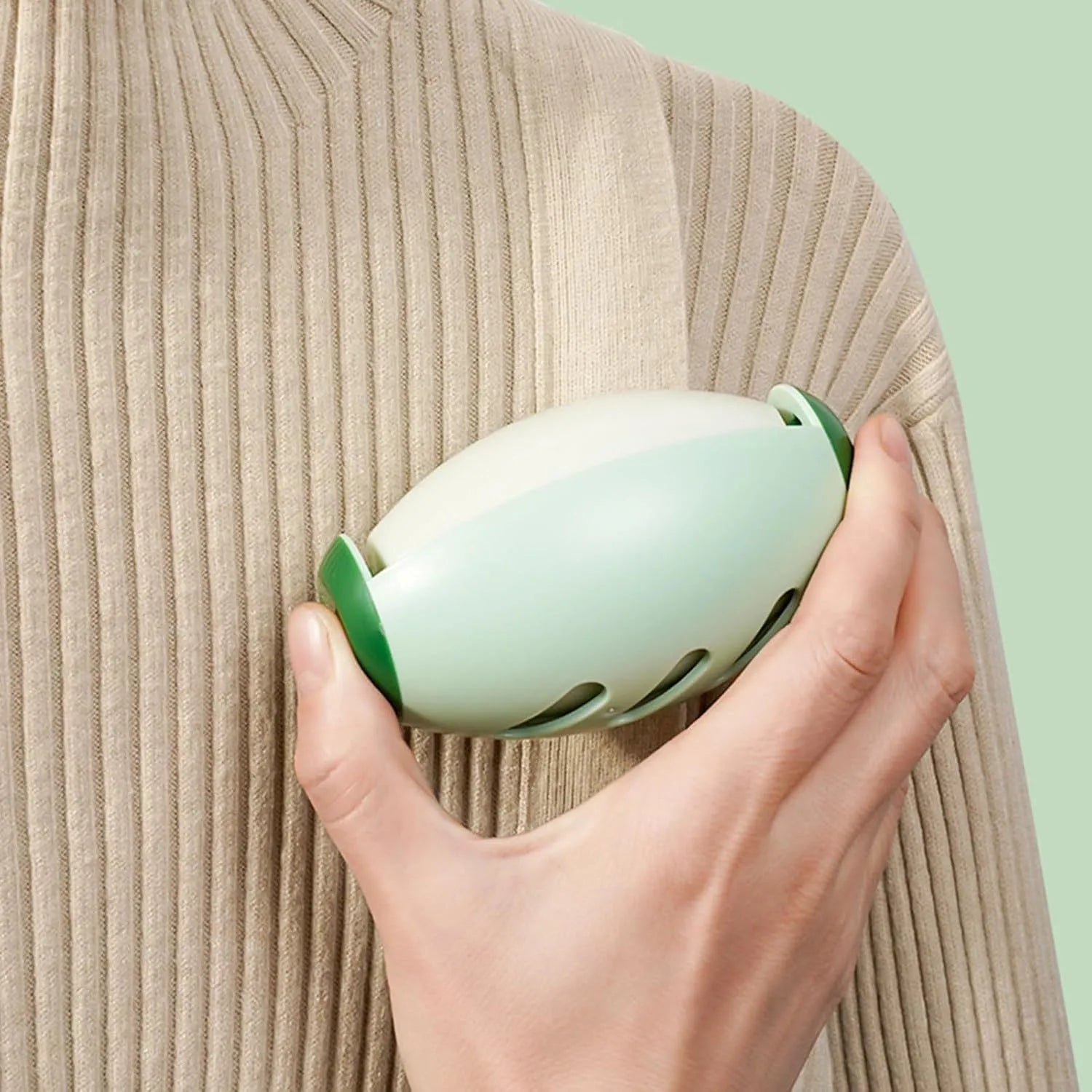 Green and white washable reusable gel lint roller balls for portable pet hair removal.