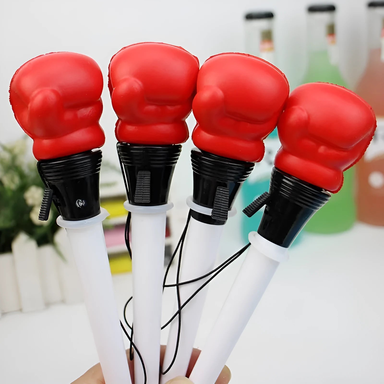 Four black pressure relief ejection pens with a plug-in sleeve fidget mechanism and 0.7mm bullet tips.