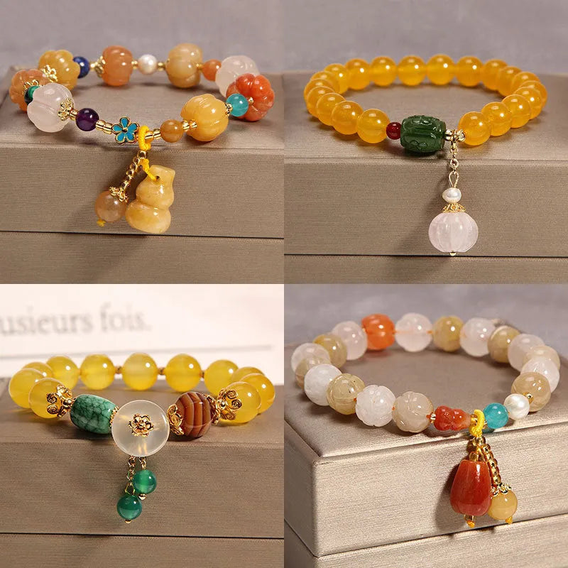 Yellow agate crystal bracelet with gold silk cord on wrist showing adjustable closure and bead detail