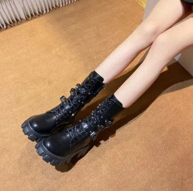 Women's black mid-calf knight boots with large metal buckle and side zip on a white background.