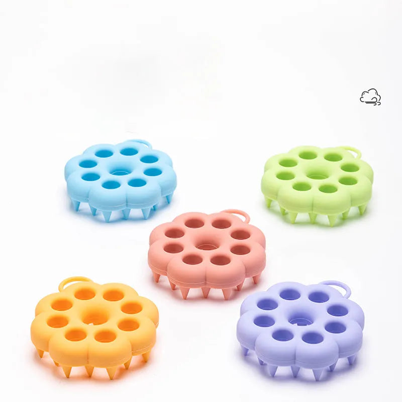 Blue silicone pet grooming brush with soft pins and ergonomic handle for wet or dry use.