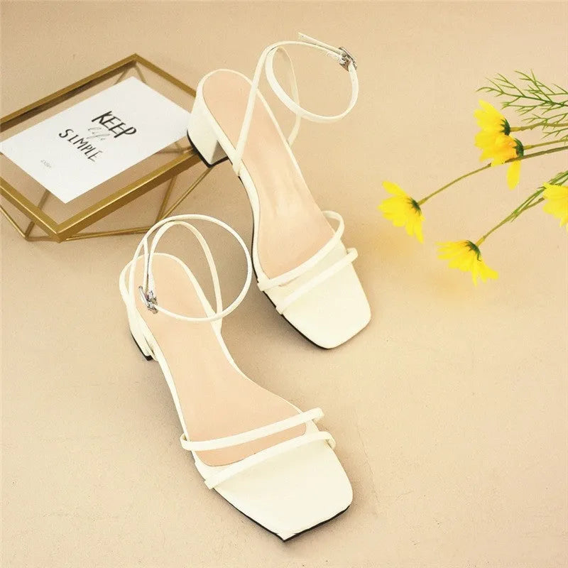 Beige women's stiletto sandals with chunky block heel and square toe design, showing adjustable ankle buckle closure