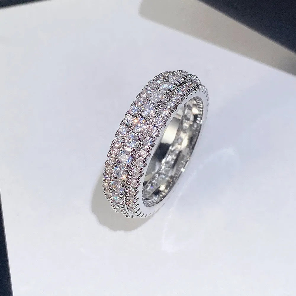 Personalised geometric ring with triangle zircon inlay in white gold finish on a hand.