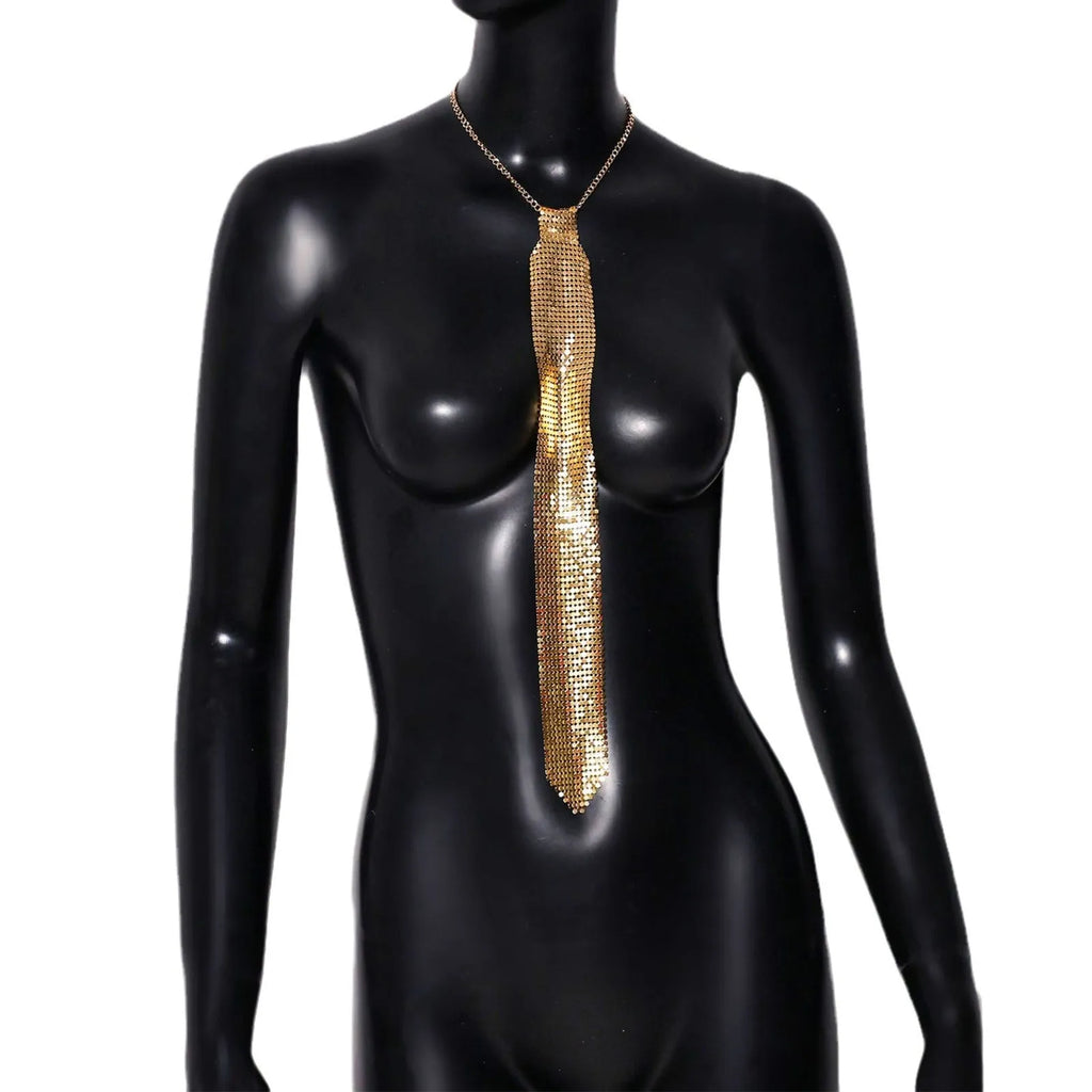 Silver metal sequin bow tie with arrow-style pointed ends on a black background