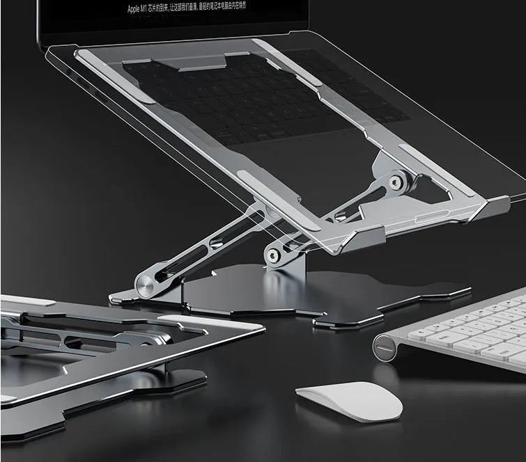 Grey portable aluminum laptop stand shown folded and in use with a silver laptop, demonstrating its adjustable angle.