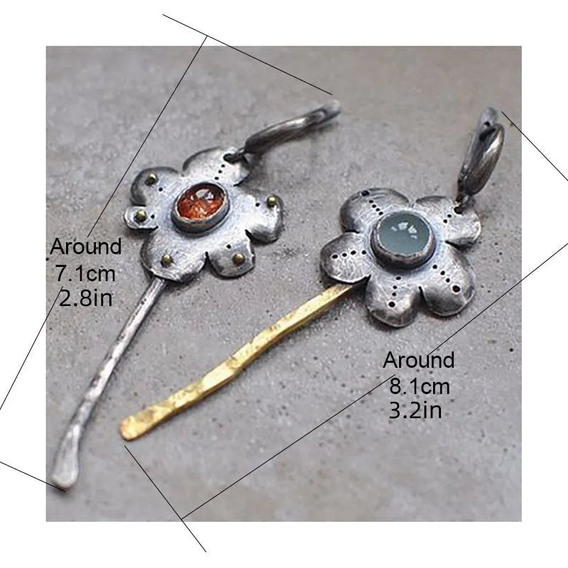 Geometric floral retro earrings with two-tone asymmetrical design and long drop style.