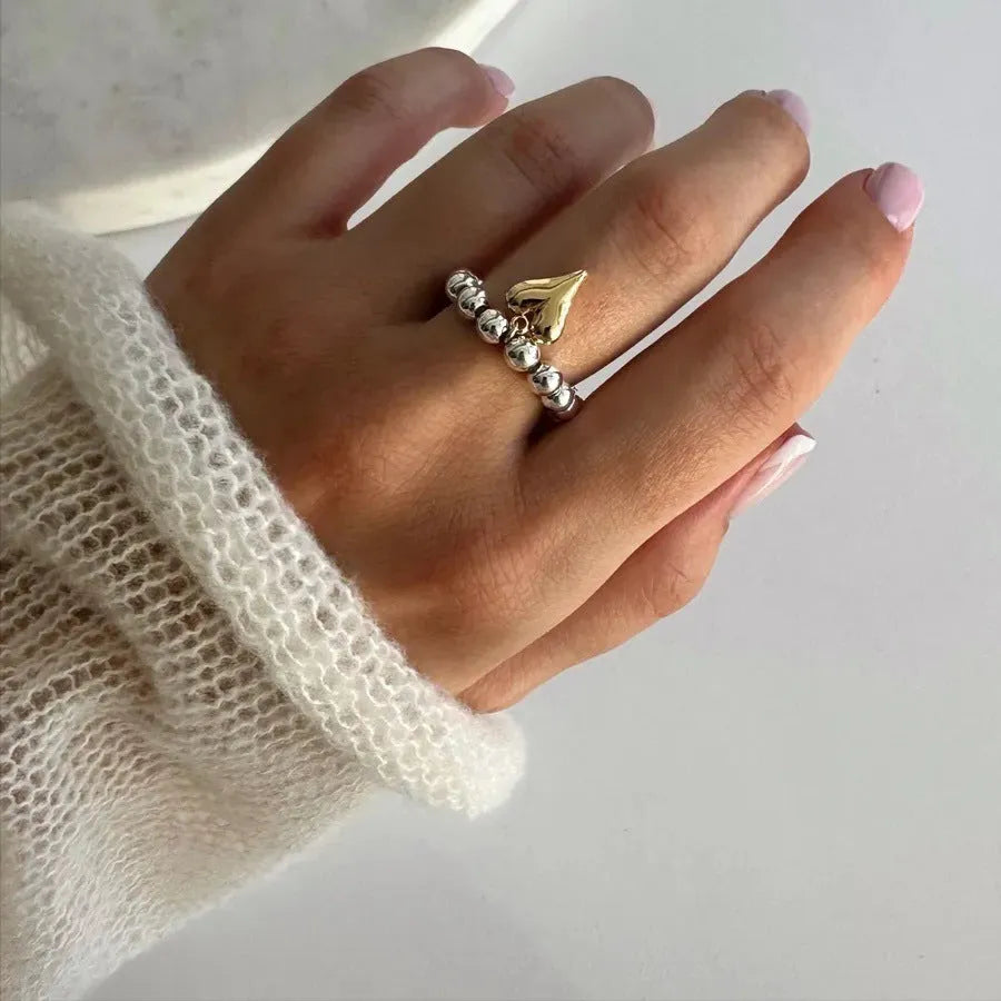 Handmade beaded elastic string love ring with geometric heart design in gold or white colours