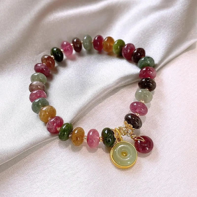 Colourful natural tourmaline abacus bead bracelet with a rabbit pendant charm.