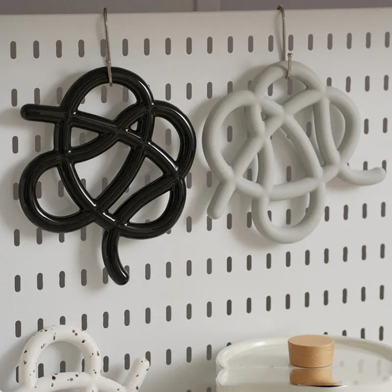Ceramic heat-proof mat in an irregular shape on a kitchen table
