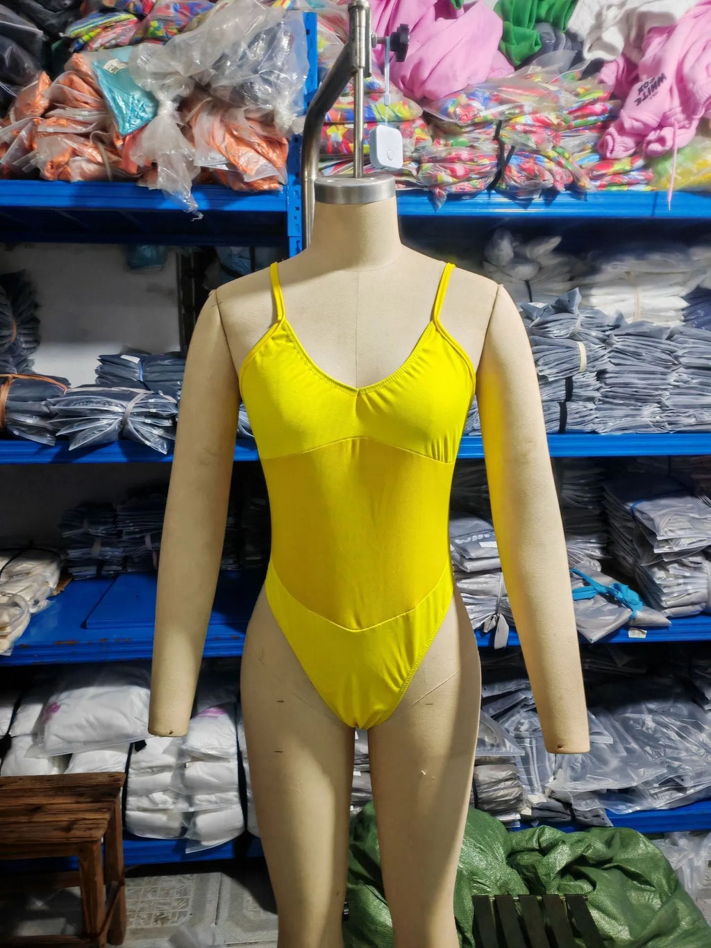 Black women's one-piece swimsuit with transparent mesh panels and banded design.