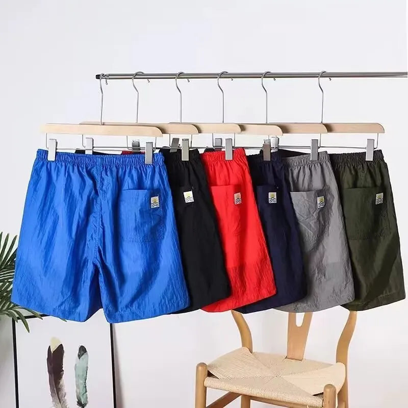 Men's quick-drying straight-leg sports shorts in army green, shown flat.