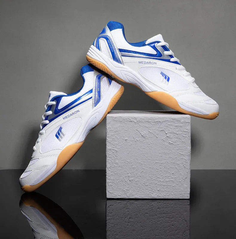 White table tennis sneakers with mesh upper and rubber sole in red or blue accents