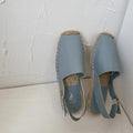 Women's flat sandals in retro fisherman style with canvas upper, soft leather, and animal pattern in yellow colour.